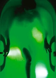 A bather relaxing in a softly lit therapeutic bath.